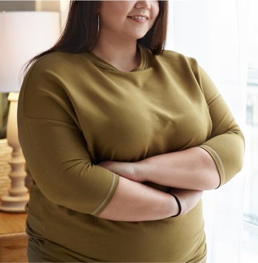 Smiling white woman outdoors.