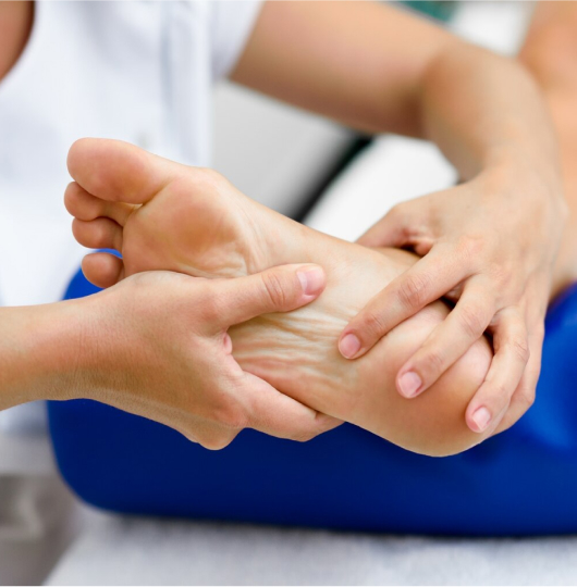 Podiatry 2 Doctor’s hands examining a patient’s foot.